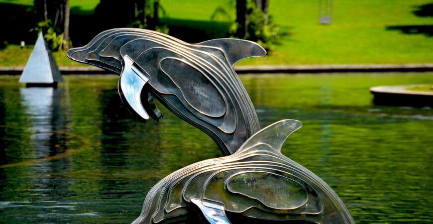 metal sculptures of dolphins